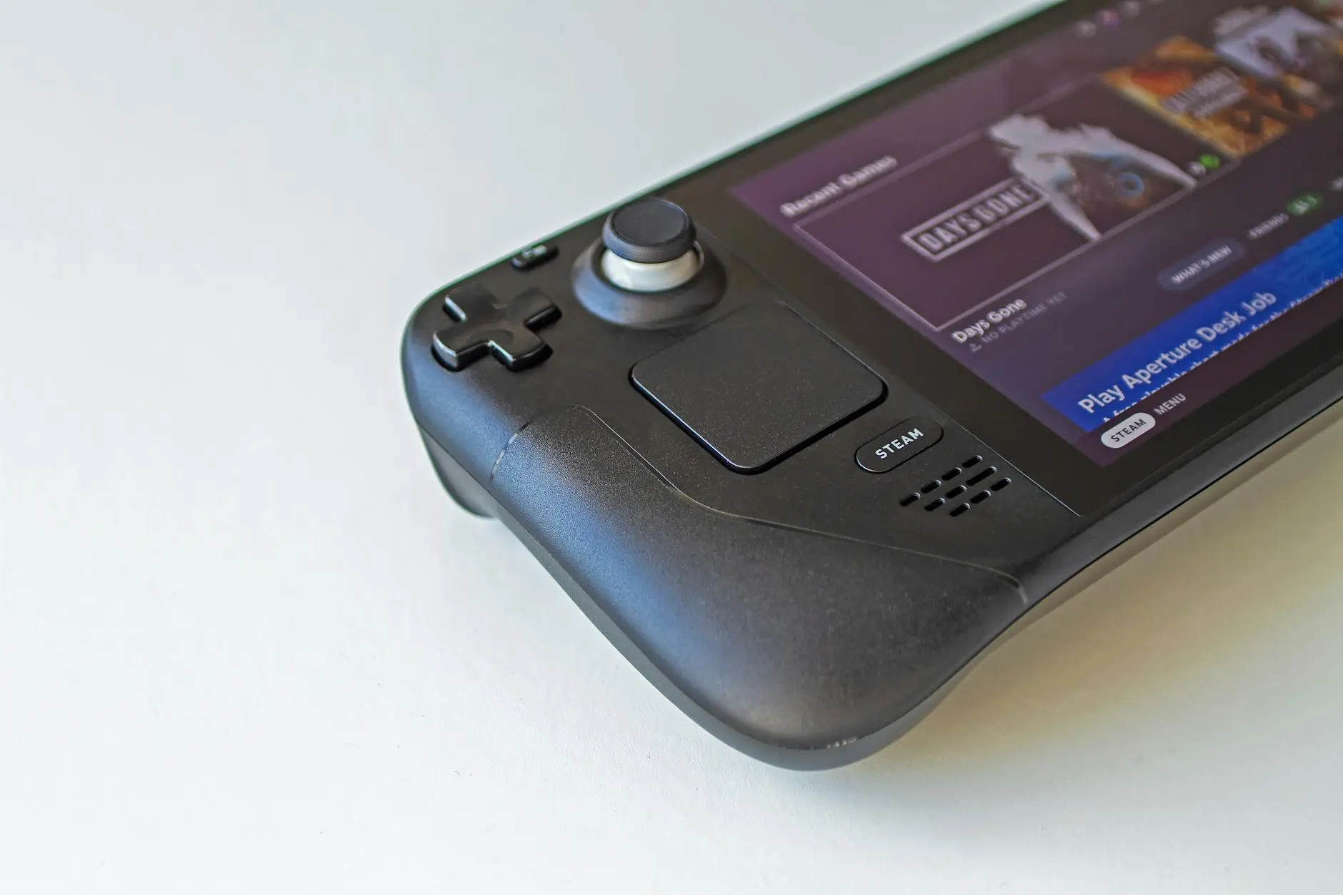 Steam handheld device showcasing the Steam store interface with game titles.