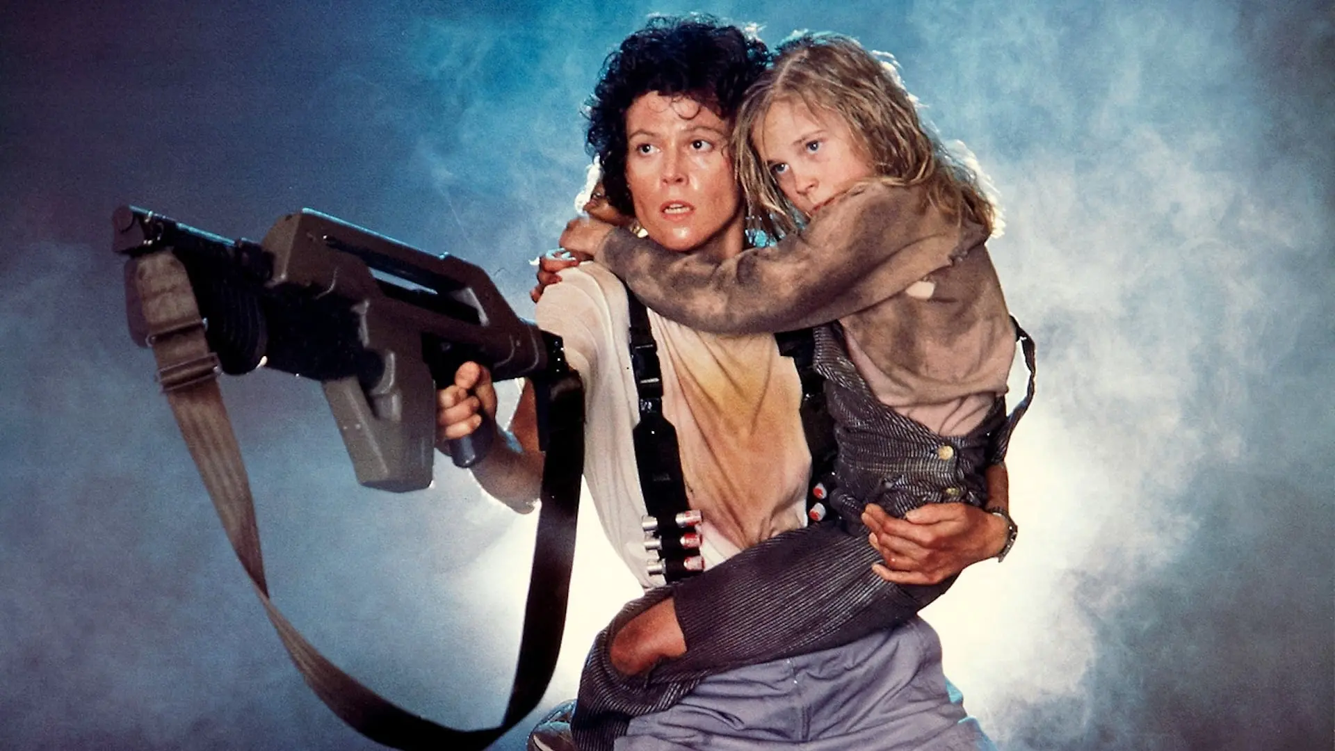 Ellen Ripley holding a young girl and carrying a pulse rifle amidst smoke in Aliens (1986).