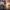 Pirate ship with black assassin flag sailing Caribbean waters at sunset